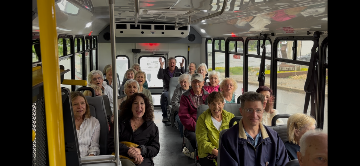 A group inside a bus heading to a day trip.
