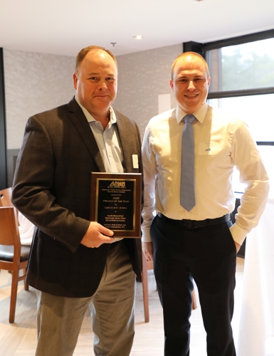 Corey Almas holding award plaque next to Christopher Ross from HRC