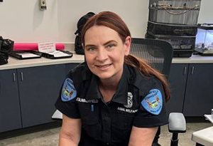 Female Animal Welfare Officer Elizabeth Summerfield seated at desk inside Animal Shelter