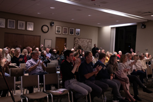 Audience at Township Hall clapping