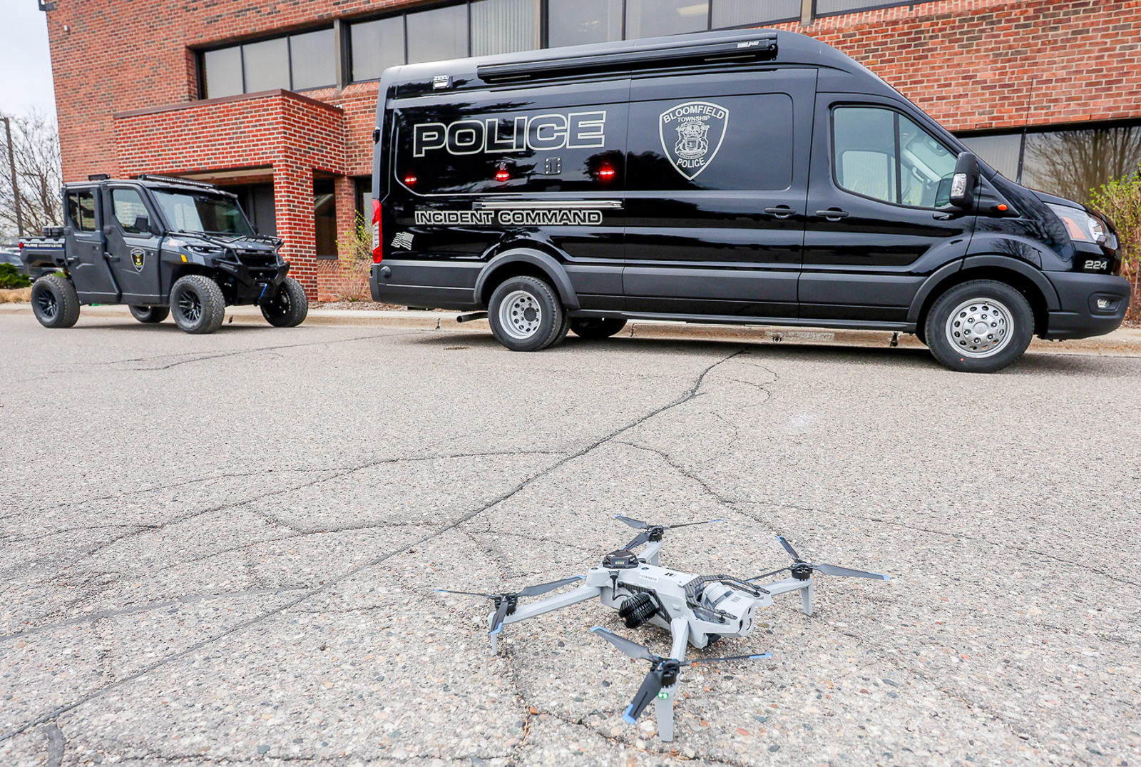 Police UTV behind Incident Command Van with Drone on ground in foreground 